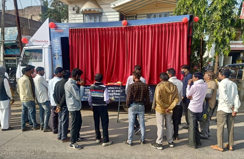 Farmers inspecting a new tractor during a rural launch activation