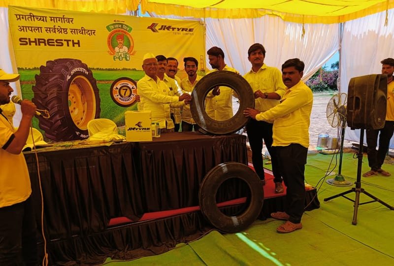 Branded Tata Ace with JK Tyre product displays at a farm campaign